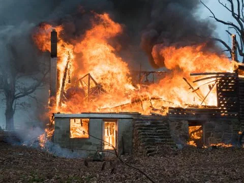 House fire engulfed by flames Stock Photos