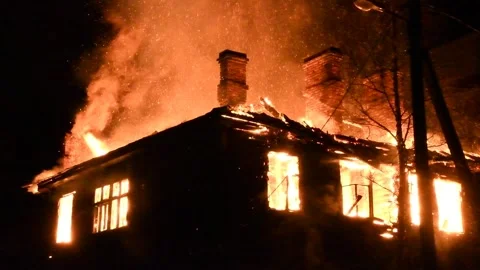 House is on fire at night, flames inside at home, burning windows. Stock Footage 294688322