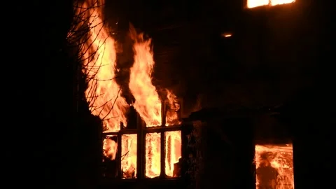 House is on fire at night, flames inside at home, burning windows. Vídeos de archivo 294688390