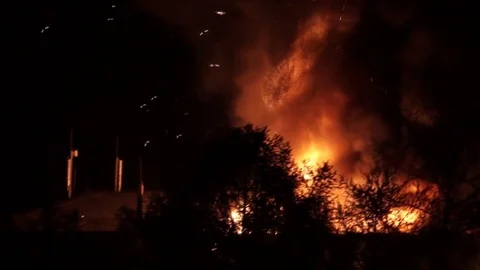 House on fire at night Stock Footage
