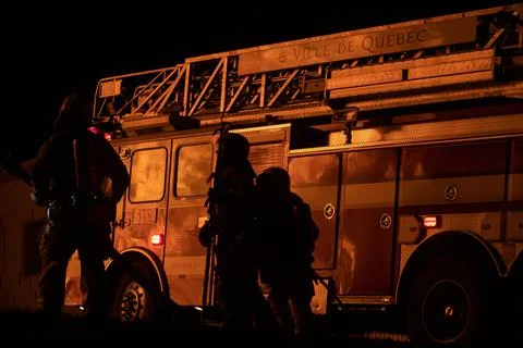 House fire reflected on fire engine. Stock Photos