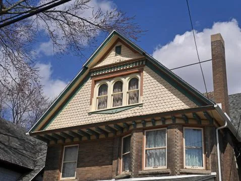 House with fish scale shingles on gable Stock Photos