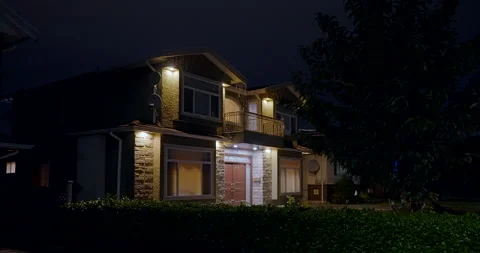 House with garage door, big tree and nice landscape at night Stock Footage
