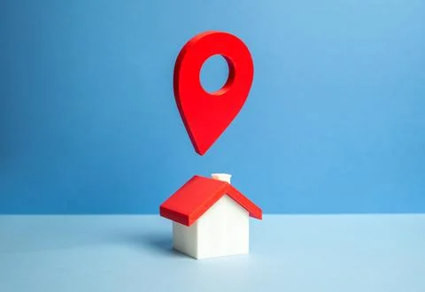 A house with a geolocation pin hovering above the roof. Navigation and loca.. Stock Photos