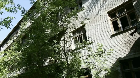 House in ghost town. Facade old destroyed brick building with broken windows in Stock Footage 110436119