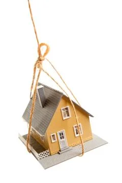 House Hanging by a String Isolated on a White Background. Foto stock