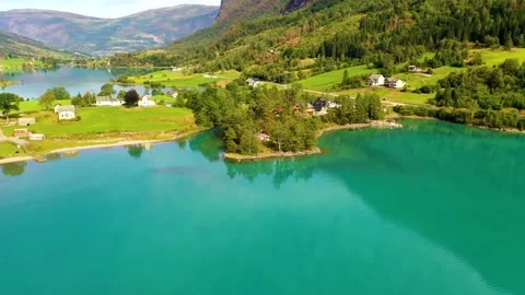 House hidden between trees surrounded by beautiful lake and landscape Stock Footage 166952823