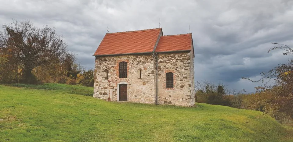 House on the hill in the middle of the forest with dramatic clouds Stock Photos