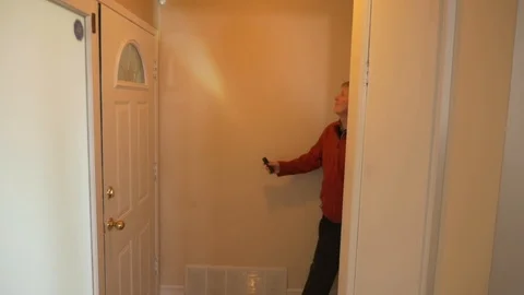 House inspector examines walls and electrical outlet Stock Footage