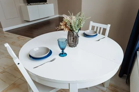 The house interior features a charming rectangular wooden table decorated w.. Stock Photos