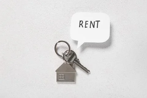House key and speech bubble with word RENT on white grunge background Stock Photos