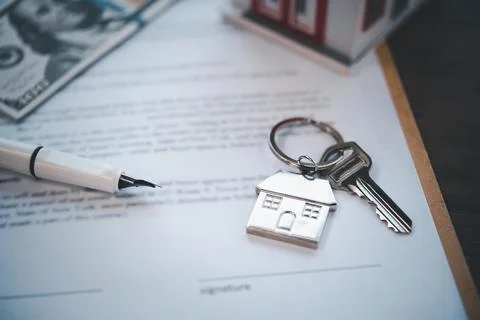 The house key is on the contract. Stock Photos