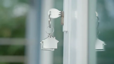 House key with a house key, made of wood in the keyhole ready to sell the con Vídeos de archivo 217964633