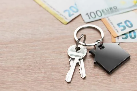 House keys with home shape keyring and euro currency Stock Photos