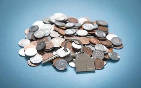 House keys over stack of coins. Stock Photos