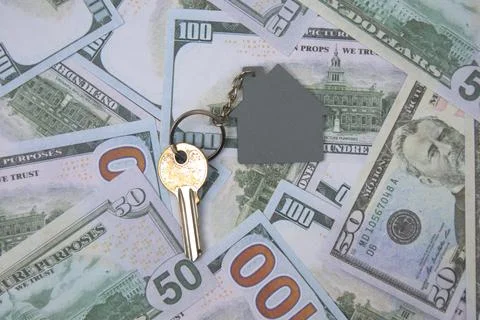 House keys on a stack of 100 dollar bills Stock Photos