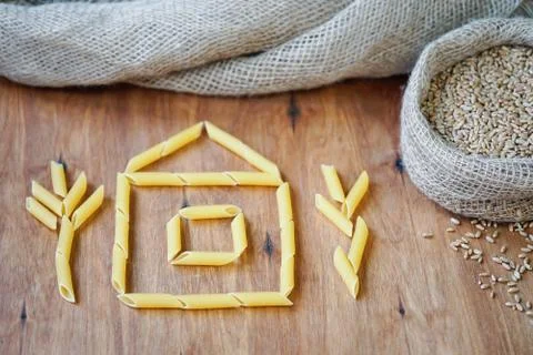 A house is laid out on the table with a paste. Stock Photos
