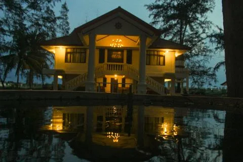 The house lights up at sunset Stock Photos