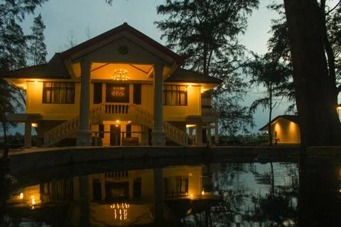 The house lights up at sunset Stock Photos