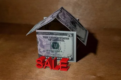 A house made of five-dollar bills. Wooden background. Stock Illustration