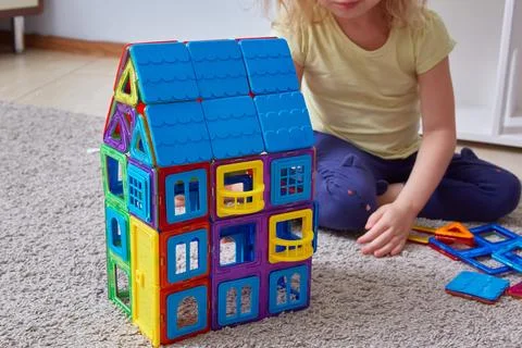 House made magnetic constructor. Faceless child background building house Stock Photos