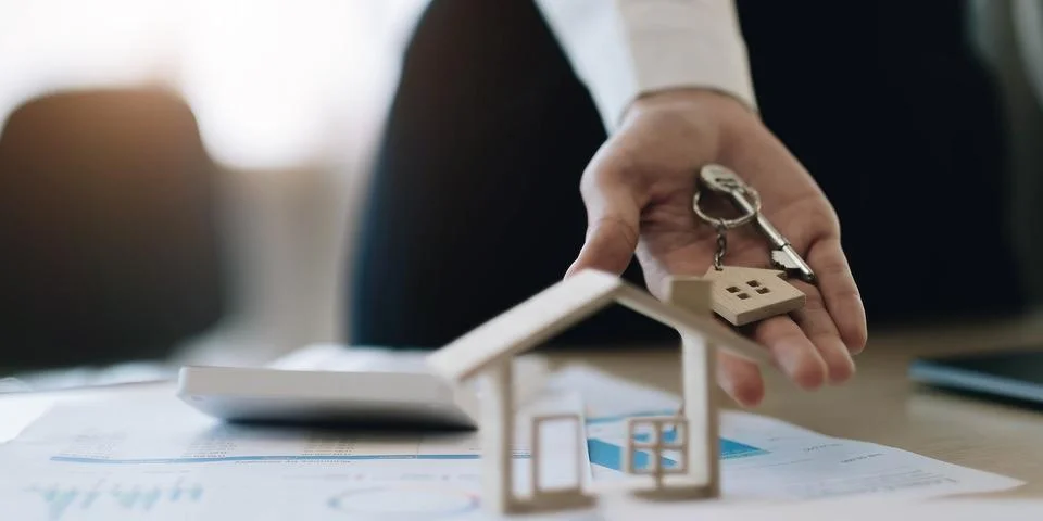 House model and key on table for finance and banking concept.Home purchase .. Stock Photos