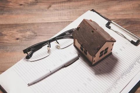 House model and notebook on the table Stock Photos
