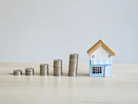 House model and stack of money coins concept of loan, saving and investment Stock Photos
