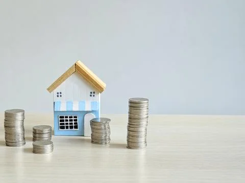 House model and stack of money coins idea of loan, saving and investment Stock Photos