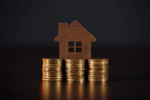 House model on coins stack. Growth of mortgage's credit concept Stock Photos