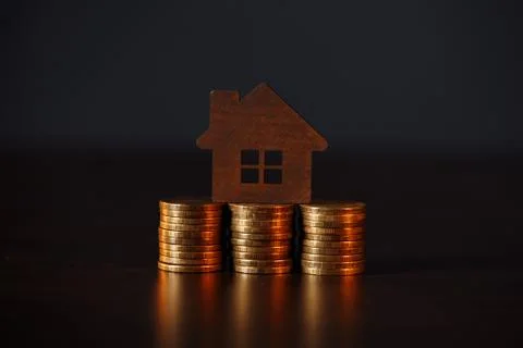 House model on coins stack. Property investment concept Stock Photos
