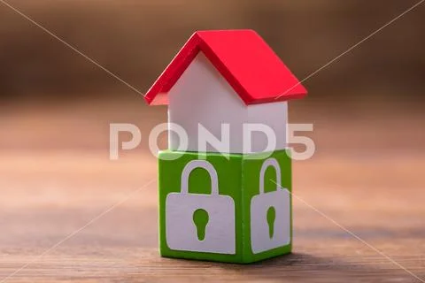 House Model On Green Block With Lock Symbols Stock Photos