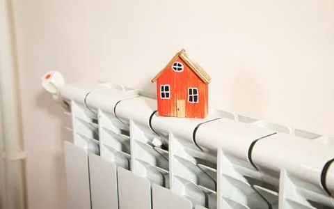House model on the heating radiator. Stock Photos
