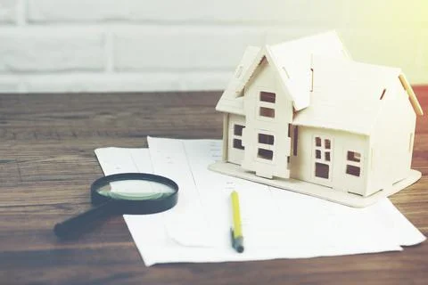 House model with magnifier on documents Stock Photos