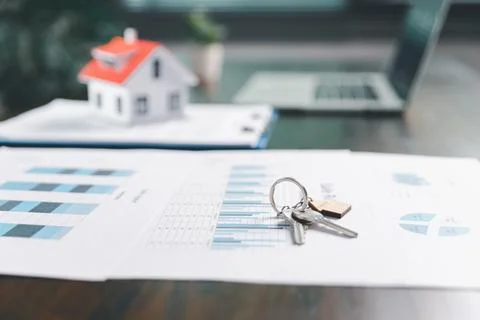 House model placed on table alongside coins, paperwork symbolizes real esta.. Stock Photos