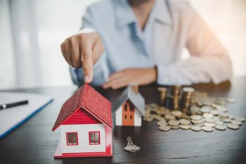 House model with stack coins, business hand is planning savings money of coin Foto stock