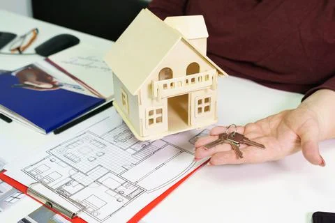 House model on table with documents in real estate agency office concept Fotos de archivo