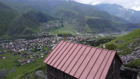 A house on a mountain in Stepantsminda overlooking the Mount Kazbek (Kazbegi) Stock Footage 199388306