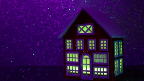 House with multi-colored glowing windows on a background that changes colors Stock Footage 265006131