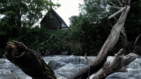A house near a tiny low waterfall, with clean fresh river water falling Stock Footage 110257080