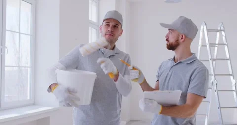 House painter and decorator professional service team, male workers planning Stock Footage 341586615