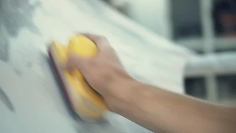 House painter manually polishes the surface of the car Stock Footage 98705664