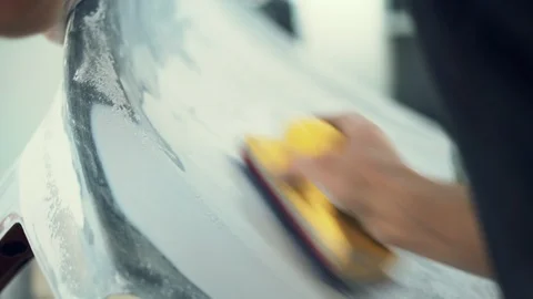 House painter manually polishes the surface of the car Stock Footage 98706349