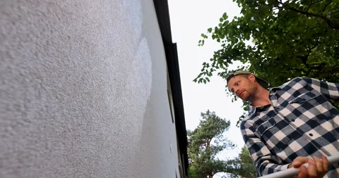 House painter restore paint on building exterior with roller 스톡 동영상 341576261