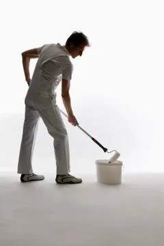 A house painter using a paint roller Stock Photos