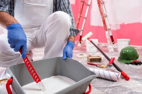 House painter worker at work in the construction site. Building. Stock Photos