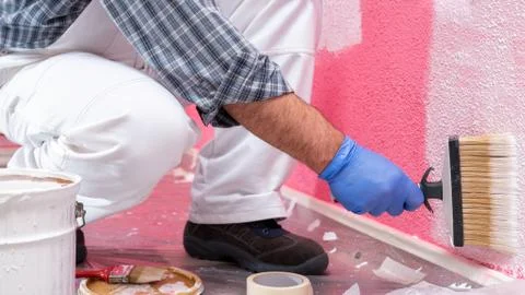 House painter worker at work in the construction site. Building. Stock Photos