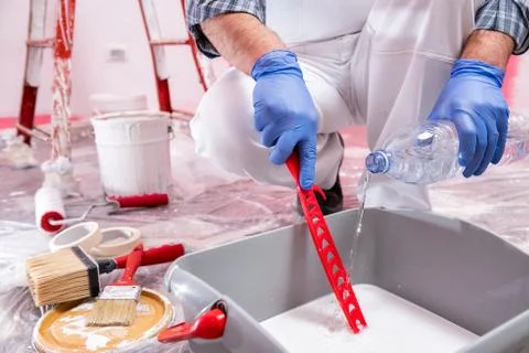 House painter worker at work in the construction site. Building. Stock Photos