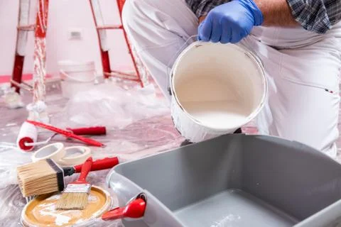 House painter worker at work in the construction site. Building. Stock Photos