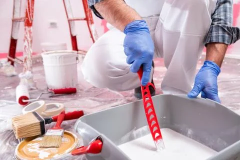 House painter worker at work in the construction site. Building. Stock Photos